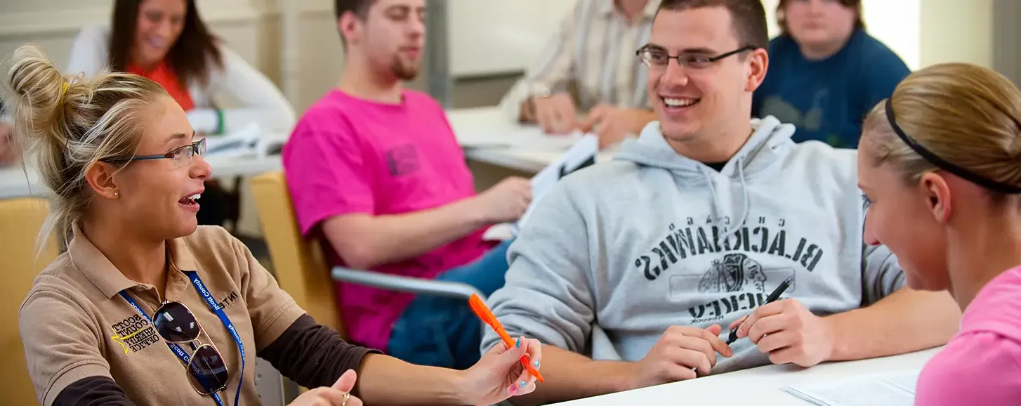 Students in a classroom discussing course materials.